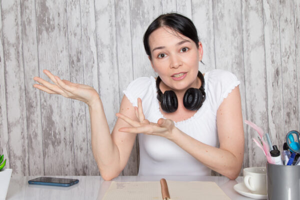 a woman with headphones around her neck